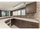 Sunroom bar with wood cabinets and a curved countertop at 2119 Zipperer Rd, Bradenton, FL 34212