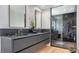 Modern bathroom with double vanity, frameless shower, and herringbone tile at 2133 Oriole Dr, Sarasota, FL 34239