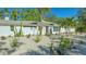 Bright white house with modern landscaping and palm trees at 2133 Oriole Dr, Sarasota, FL 34239