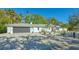 Modern home exterior featuring a dark garage door and gravel landscaping at 2133 Oriole Dr, Sarasota, FL 34239