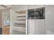 White kitchen cabinets with pull-out drawers and built-in microwave at 2133 Oriole Dr, Sarasota, FL 34239