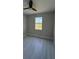 Light filled bedroom with wood-look tile flooring and a picturesque view from the window at 2323 Zuyder Ter, North Port, FL 34286