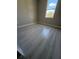 Bright bedroom with light tile flooring, a large window, base molding, and neutral paint at 2323 Zuyder Ter, North Port, FL 34286