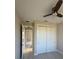 Bright bedroom with closet and view of hallway showcasing a ceiling fan and modern finishes at 2323 Zuyder Ter, North Port, FL 34286