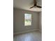 Bedroom with ceiling fan and natural light from window overlooking the yard at 2323 Zuyder Ter, North Port, FL 34286