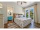 Bright bedroom with queen bed, ensuite bathroom access, and sliding glass doors to balcony at 238 Oak Ave, Anna Maria, FL 34216