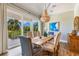 Bright dining room with wooden table, chairs, and access to a deck at 238 Oak Ave, Anna Maria, FL 34216