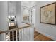 Upstairs hallway with staircase, hardwood floors and nautical-themed art at 238 Oak Ave, Anna Maria, FL 34216