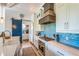 Modern kitchen with stainless steel appliances and blue tile backsplash at 238 Oak Ave, Anna Maria, FL 34216