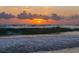 Orange sunset over ocean waves at 238 Oak Ave, Anna Maria, FL 34216