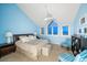 Relaxing bedroom with light blue walls, king-size bed, and water views at 30 Tidy Island Blvd, Bradenton, FL 34210