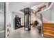 Modern entryway with a glass elevator and wooden staircase at 30 Tidy Island Blvd, Bradenton, FL 34210