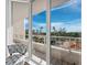 Spacious balcony with comfortable seating, a tiled floor, and glass railings overlooking picturesque scenery at 3060 Grand Bay Blvd # 124, Longboat Key, FL 34228