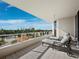 Spacious balcony with lounge chairs and glass railings, providing a serene outdoor retreat with stunning views at 3060 Grand Bay Blvd # 124, Longboat Key, FL 34228