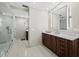 Bright bathroom features a glass shower, marble floors, modern vanity, and an illuminated mirror at 3060 Grand Bay Blvd # 124, Longboat Key, FL 34228