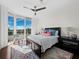 Charming bedroom with a stylish rug, comfortable bed, and large windows leading to a private balcony with views at 3060 Grand Bay Blvd # 124, Longboat Key, FL 34228