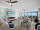 Modern living room showcasing a fireplace, comfortable seating, and sliding glass doors to an outdoor patio with ocean vistas at 3060 Grand Bay Blvd # 124, Longboat Key, FL 34228