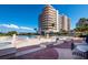 Resort-style pool area with sun loungers and lush landscaping, offering a relaxing oasis at 3060 Grand Bay Blvd # 124, Longboat Key, FL 34228