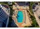 Aerial view of a luxury condo complex showcasing a pool with lounge chairs, umbrellas and lush landscaping at 3060 Grand Bay Blvd # 124, Longboat Key, FL 34228