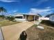 Front view of manufactured home with driveway and landscaping at 308 Danube Cir, Bradenton, FL 34207