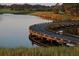 Wooden bridge over water, reflecting the surrounding nature at 3123 Founders Club Dr, Sarasota, FL 34240