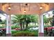 Luxury community clubhouse entrance with lush landscaping and palm trees at 3123 Founders Club Dr, Sarasota, FL 34240