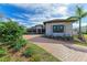 Luxury home with tile roof, stone accents, and a 3-car garage at 3123 Founders Club Dr, Sarasota, FL 34240