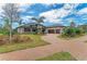 Luxury home with a paver driveway and beautifully landscaped yard at 3123 Founders Club Dr, Sarasota, FL 34240