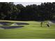 Golfers putting on a lush green golf course at 3123 Founders Club Dr, Sarasota, FL 34240