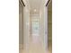 Elegant hallway leading to the main bathroom and walk-in closet at 3123 Founders Club Dr, Sarasota, FL 34240