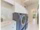 Laundry room with a sink, modern appliances, and white cabinets at 3123 Founders Club Dr, Sarasota, FL 34240