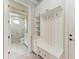 Bright laundry room with white cabinets and a bench at 3123 Founders Club Dr, Sarasota, FL 34240