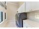 Spacious laundry room with modern appliances and white cabinets at 3123 Founders Club Dr, Sarasota, FL 34240