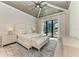 Serene main bedroom with tray ceiling and private access to the outdoor oasis at 3123 Founders Club Dr, Sarasota, FL 34240