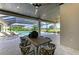 Al fresco dining area with outdoor kitchen and pool view at 3123 Founders Club Dr, Sarasota, FL 34240