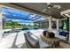 Spacious pool area with a covered patio and lounge chairs at 3123 Founders Club Dr, Sarasota, FL 34240