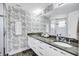 Elegant bathroom with double vanity, granite countertops, and decorative wallpaper at 317 Beach Rd, Sarasota, FL 34242