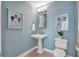 Small bathroom with pedestal sink and blue walls at 317 Beach Rd, Sarasota, FL 34242