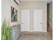 Bright hallway with stairs, storage, and a rustic dresser at 317 Beach Rd, Sarasota, FL 34242