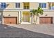 Private entrance with double wooden garage doors and a center door at 317 Beach Rd, Sarasota, FL 34242