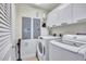 Laundry room with washer, dryer, and additional storage at 317 Beach Rd, Sarasota, FL 34242