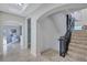 Elegant staircase with arched entryway leading to upper level at 317 Beach Rd, Sarasota, FL 34242