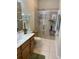 Bathroom with walk-in shower and wood vanity at 3453 Parkridge Cir # 18-101, Sarasota, FL 34243