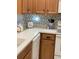 Close-up of a kitchen with white countertops and patterned backsplash at 3453 Parkridge Cir # 18-101, Sarasota, FL 34243