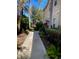 Paved walkway leads to condo with lush tropical foliage at 3453 Parkridge Cir # 18-101, Sarasota, FL 34243