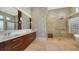 Elegant bathroom with double vanity, large shower, and glass block accents at 3598 Fair Oaks Ln, Longboat Key, FL 34228