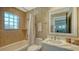 Updated bathroom features a soaking tub, tile flooring and a modern vanity at 3598 Fair Oaks Ln, Longboat Key, FL 34228