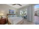 Bright bedroom with a queen bed and sliding doors leading to the patio at 3598 Fair Oaks Ln, Longboat Key, FL 34228