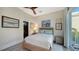 Cozy bedroom with a wicker bed frame and access to a private balcony at 3598 Fair Oaks Ln, Longboat Key, FL 34228