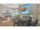 Bright dining area with a round wooden table and access to backyard at 3598 Fair Oaks Ln, Longboat Key, FL 34228